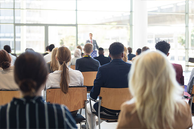 Attendees seated in a classroom training session facing an instructor at the front of the room