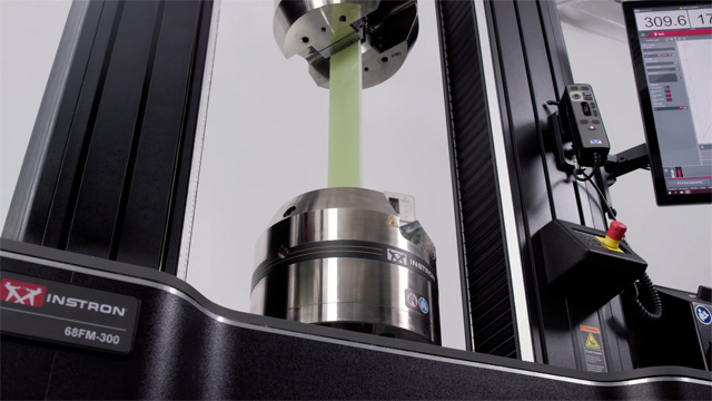 | Instron Close-up of an Instron 68FM-300 floor model universal testing machine with hydraulic wedge grips.