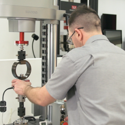 | Instron Instron technician performing calibration on a universal testing system.