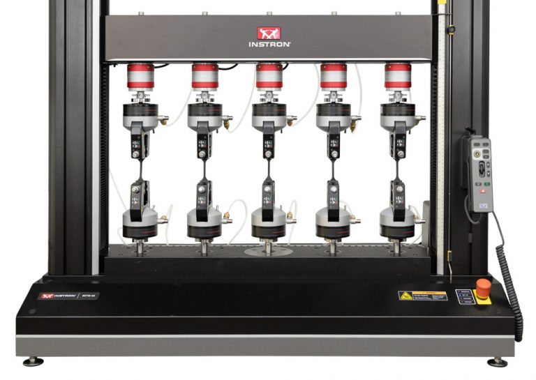 Instron 68TM-30 table model universal testing system configured with five parallel test stations and pneumatic grips for high-throughput testing.
