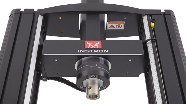 Torsion add-on module mounted on the crosshead of a 6800 Series 68TM table model, enabling combined axial and torsion testing. | Instron