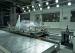 Crash test dummy ejected forward during an airbag deployment test on the Instron CSAadvanced sled system with smoke from pyrotechnic devices visible